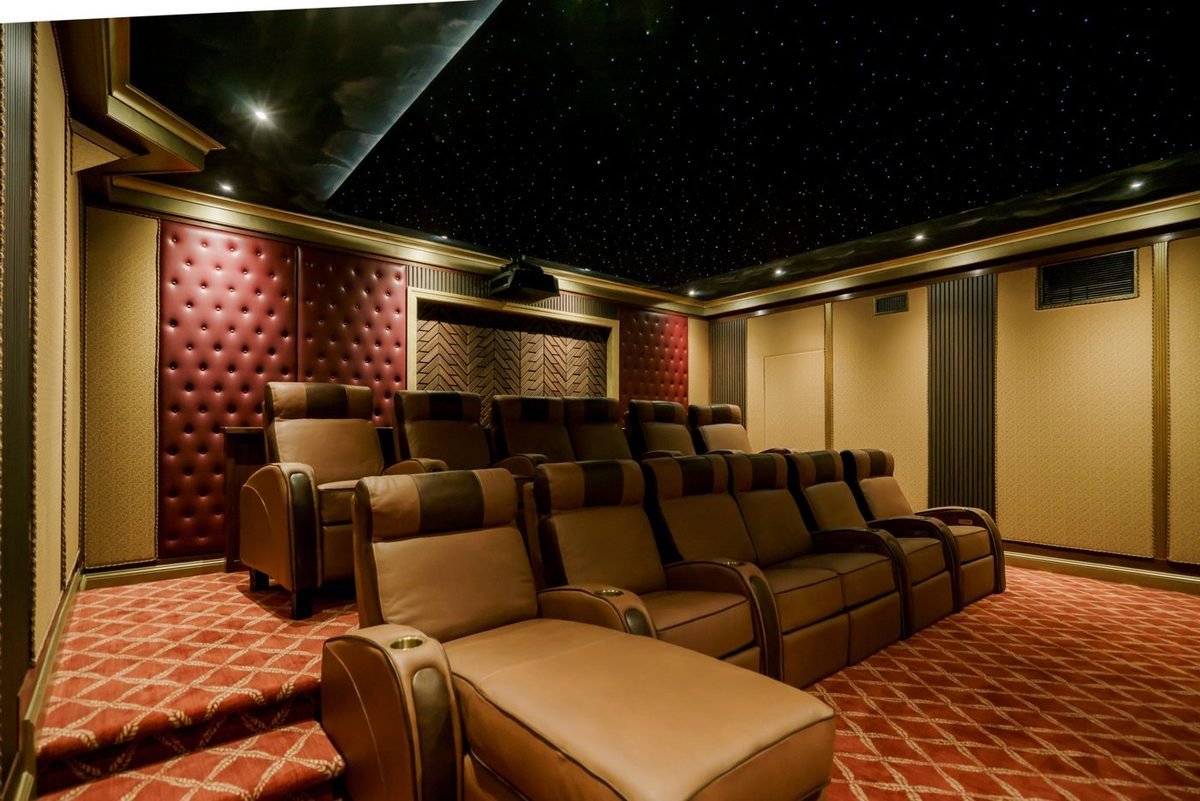Home theater with a fiber-optic star ceiling and tan leather recliners